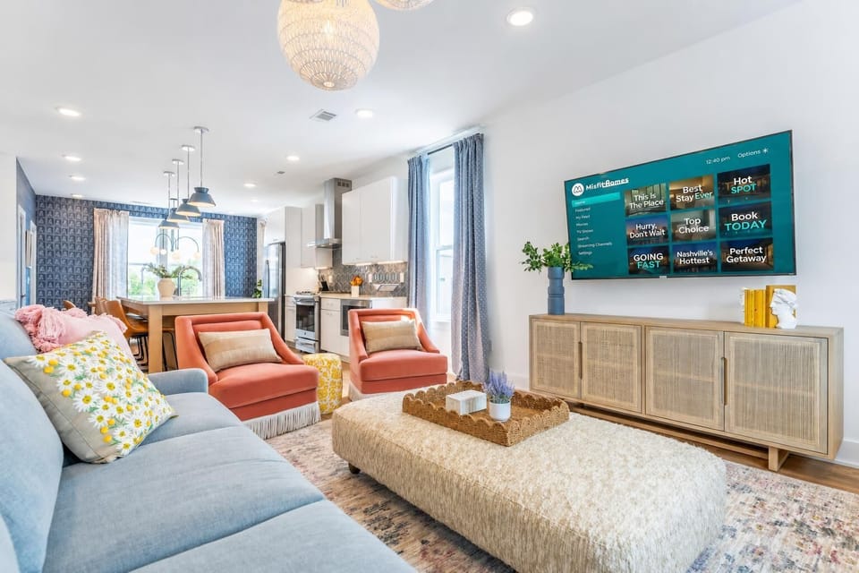 The TV, sofa, and kitchen blur together in one open space, everyone's in the same room whether ordering takeout or catching a kickoff, make your reservation today