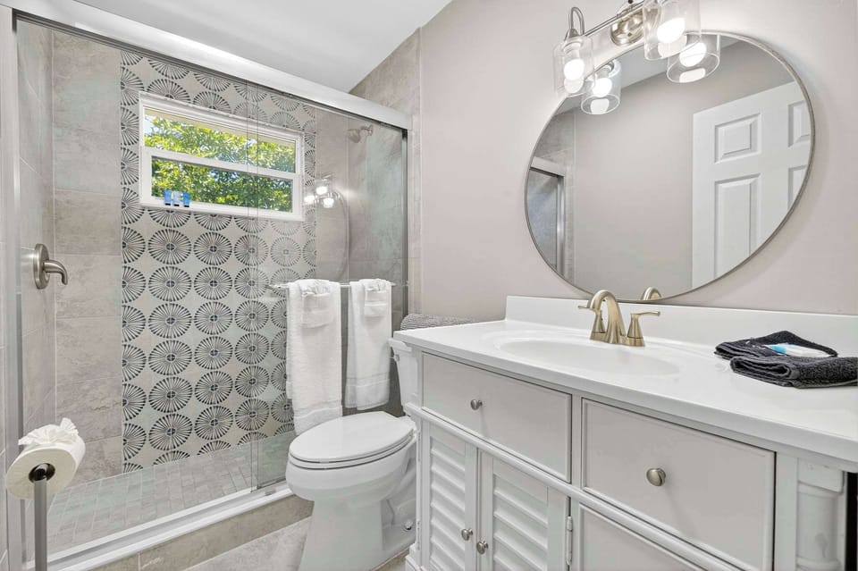 Newly updated bathroom with a beautifully tiled walk-in shower