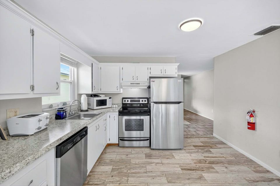 Newer appliances and all the cookware and dishes to prepare a feast or a quick beach snack