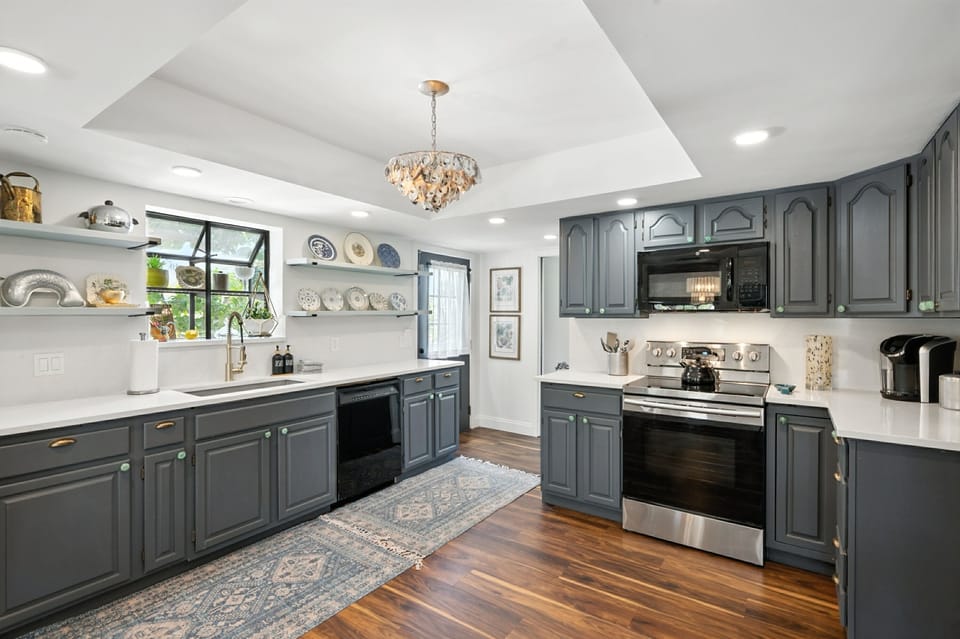 Vintage Coastal kitchen with quartz counters and stainless appliances