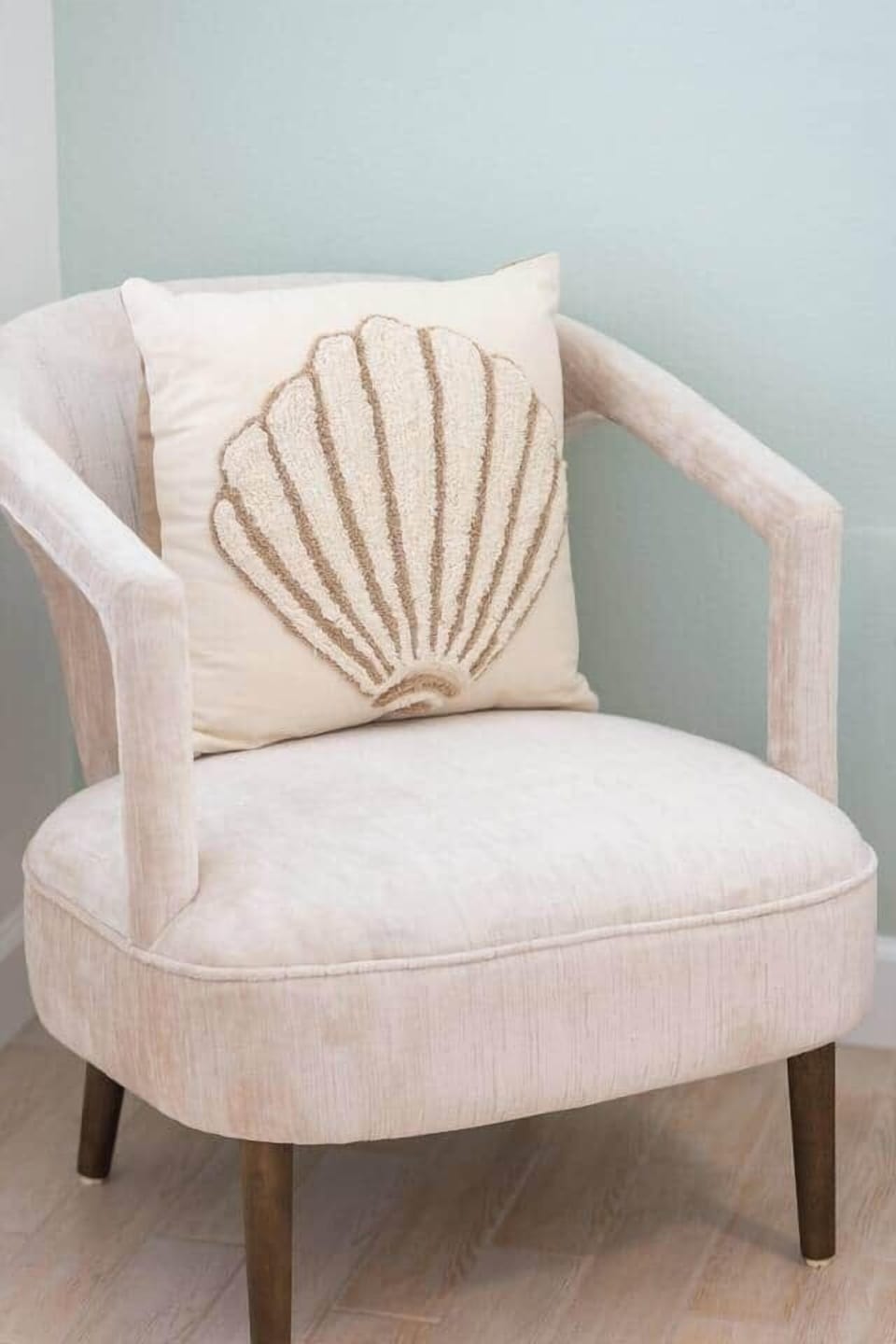 Lounge in style—luxe chair with curated pillow, made for slow island moments.