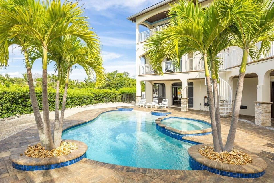 Canal front luxury private resort home with beach-entry pool and spa
