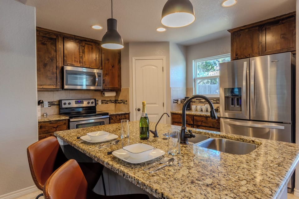 Fully equipped kitchen with bar seating. Perfect for quick bites or cocktails.