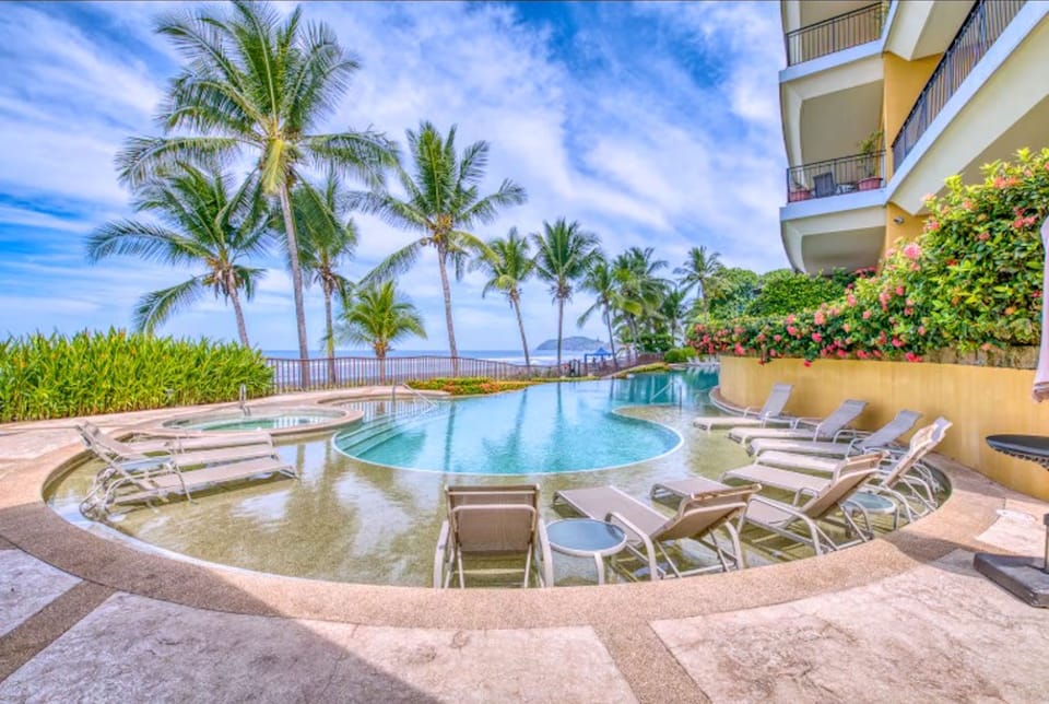 Watch the Surfers at Sunset as you enjoy a Drink at the Pool. Book Now!