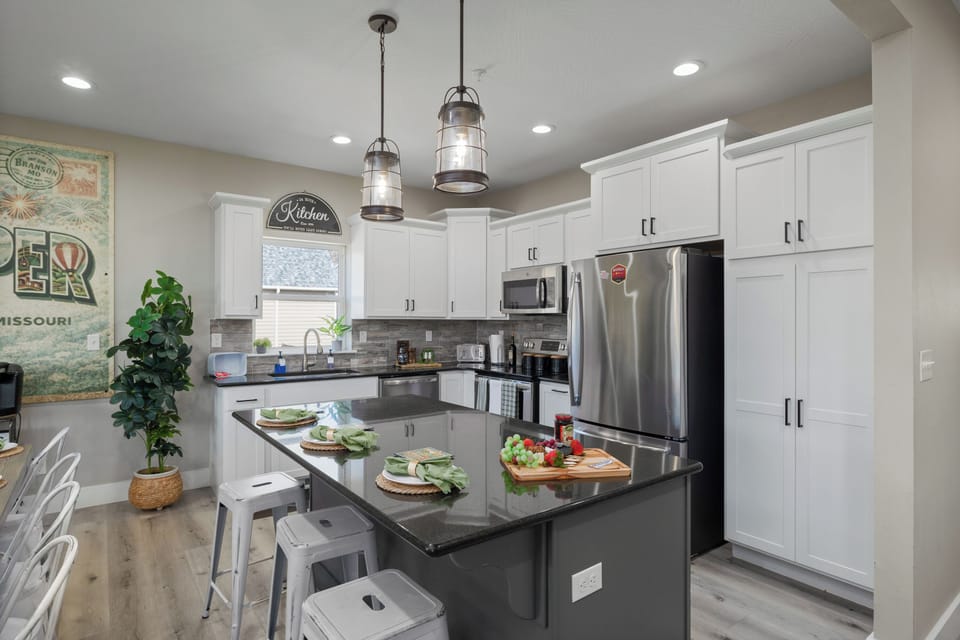 The kitchen island has 3 additional bar seats.