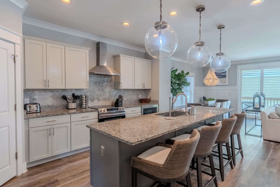 Modern, open kitchen with updated appliances and an island featuring bar seating.