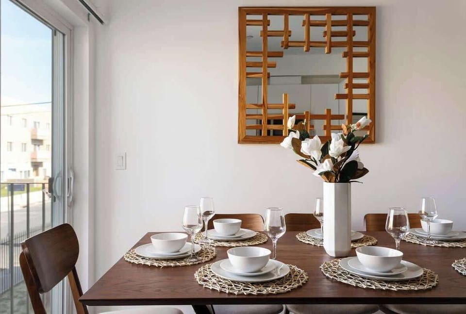 Dining area with modern wall decor and table setting.
