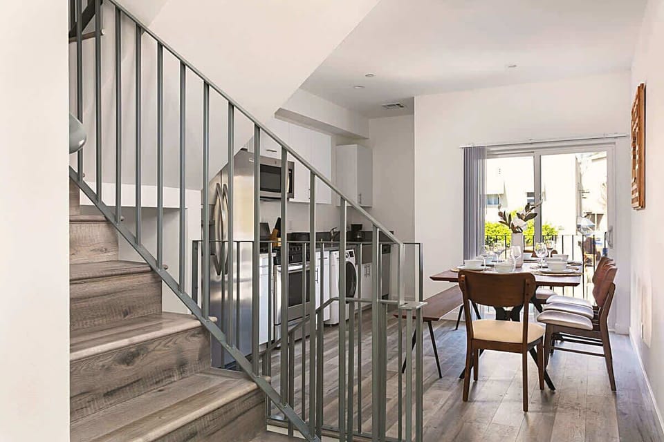 Open-concept space connecting dining area and staircase.