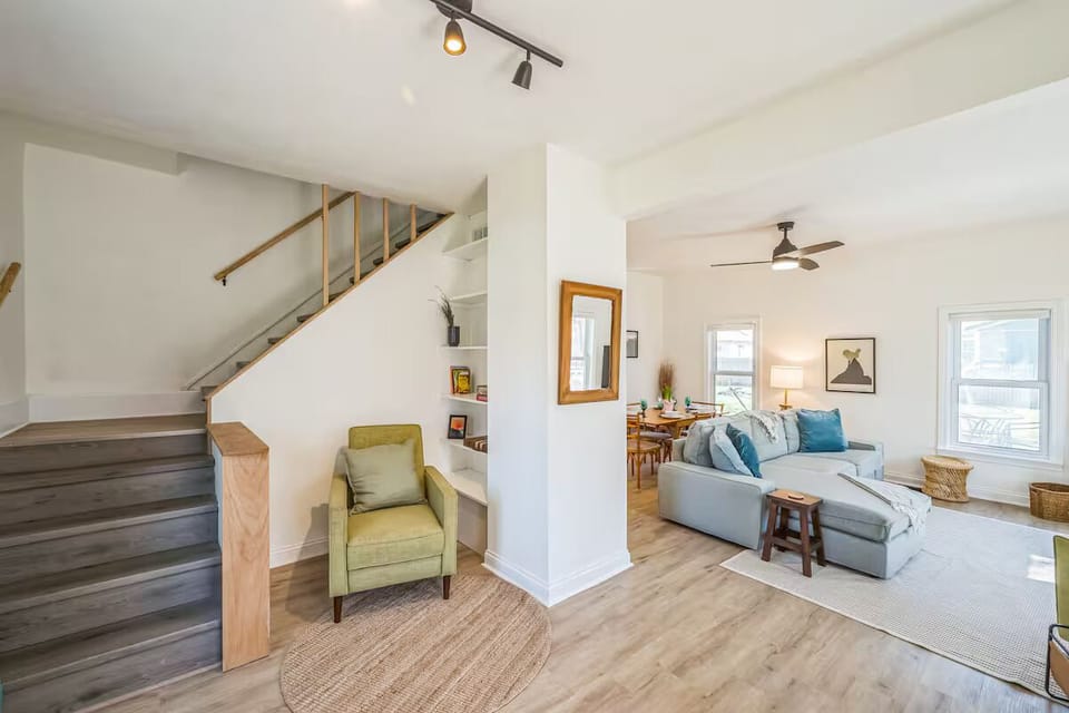 Open concept layout with cozy sectional and reading nook.