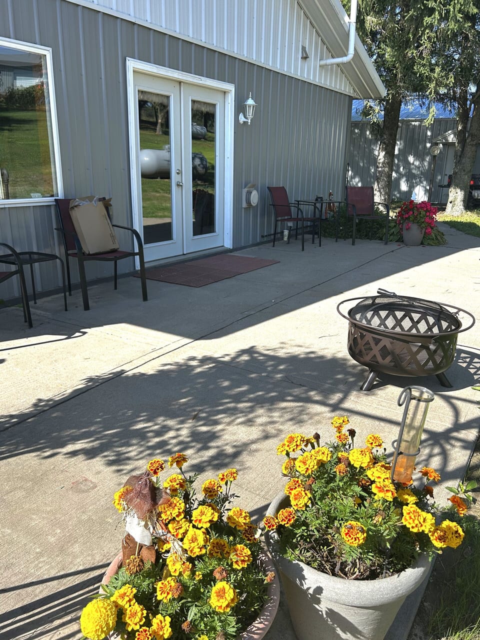 private back patio with seating, gas grill and firepit. 