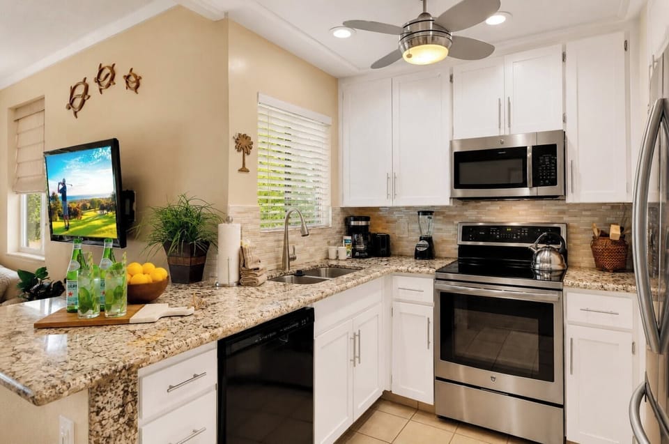 The fully equipped kitchen features stainless steel appliances, ample counter space, and everything you need for home-cooked meals.