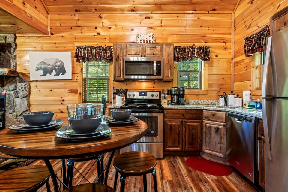 The fully equipped kitchen features stainless steel appliances, granite countertops, and all the essentials to whip up anything from coffee to a home-cooked meal.