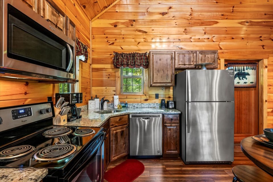 Whether you`re brewing morning coffee or cooking dinner together, this fully equipped kitchen has everything you need—including stainless steel appliances and charming cabin touches.
