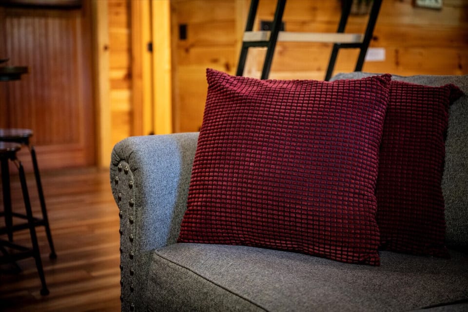 Snuggle into this comfy corner of the cabin, where textured pillows and plush seating invite you to relax and stay a while.