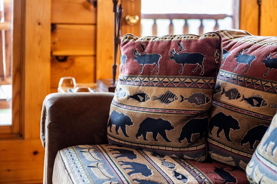 Rustic touches are everywhere—even the pillows are part of the Smoky Mountain charm. Settle in and feel the warmth of true cabin living.