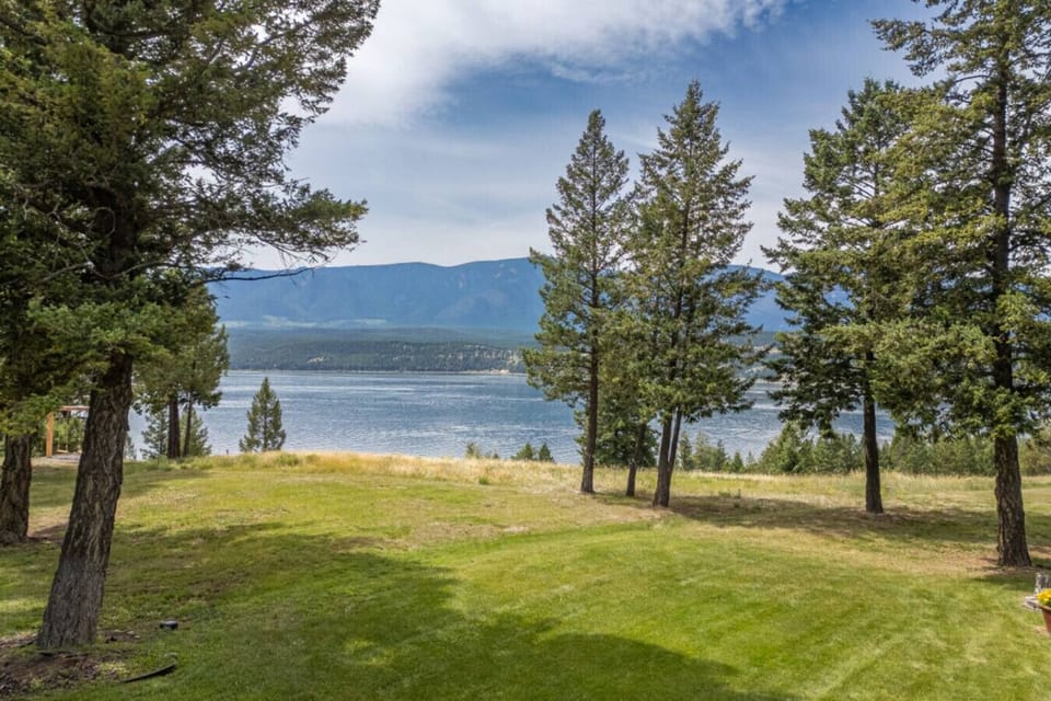Backyard of the Alpine Lake House; enjoy the private hot tub, multiple outdoor seating options with mountain and lake views.