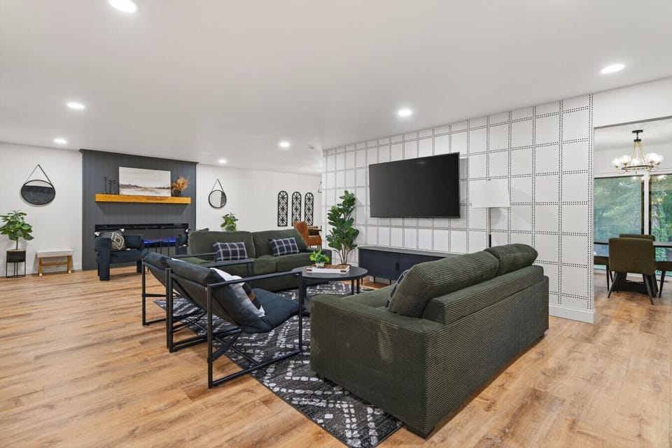 Discover a stylish, remodeled open-concept living room, kitchen, and dining area with new appliances, custom quartz countertops, and backsplash. Perfect for cooking, entertaining, and relaxing in a modern, functional space