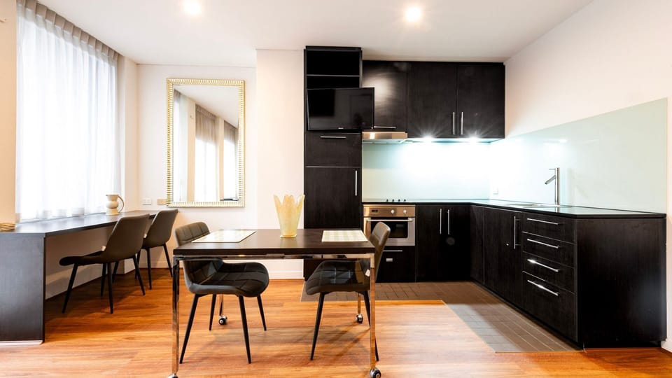Open-plan dining area and kitchen with wooden flooring