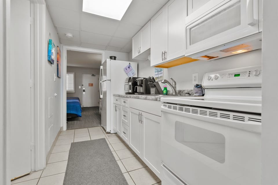 Full size fridge, range oven, microwave, coffee maker, dishes, utensils, basic pots and pans.