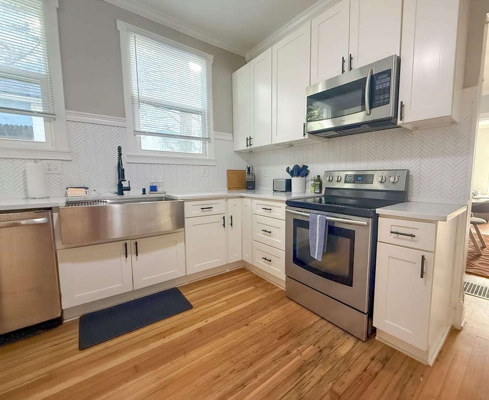 Kitchen stocked with knives, spices, cookware, and all dining essentials.