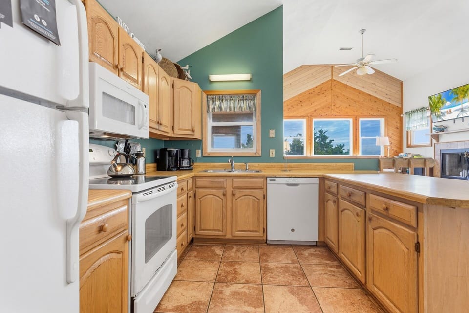 Cook up coastal favorites in the fully equipped kitchen featuring modern appliances, a Keurig, crock pot, and griddle.