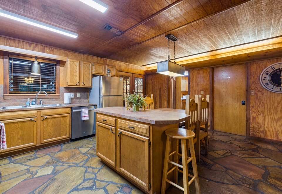 Spacious kitchen with island and bar seating.