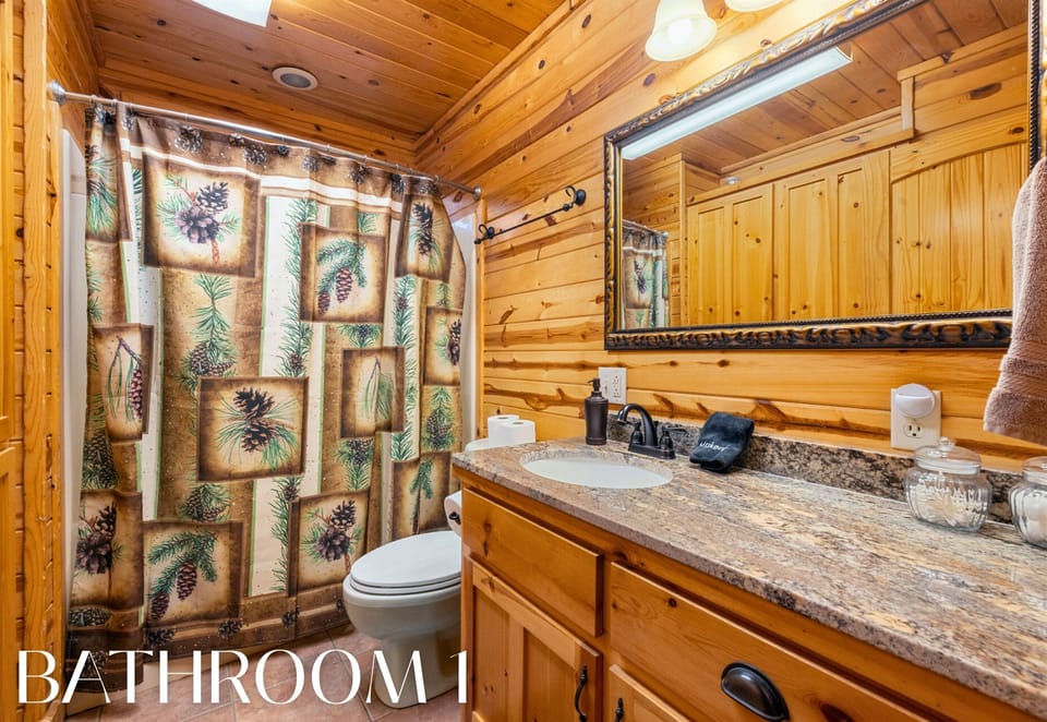 Bathroom with rustic vanity and shower/tub combo.