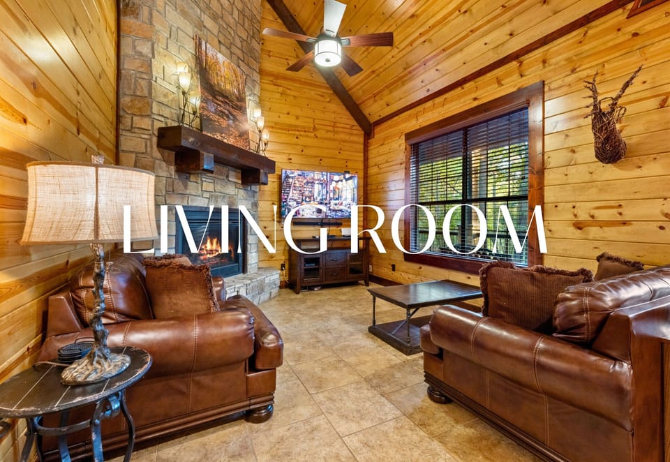 Inviting living area with leather seating and a stone fireplace — cozy perfection.