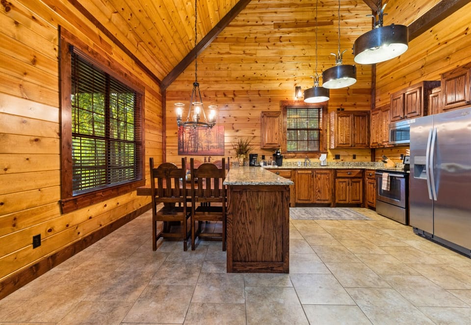 Rustic dining space with large windows to enjoy wooded views as you eat.