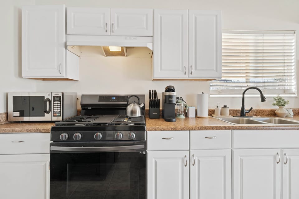 Modern appliances and white cabinetry.