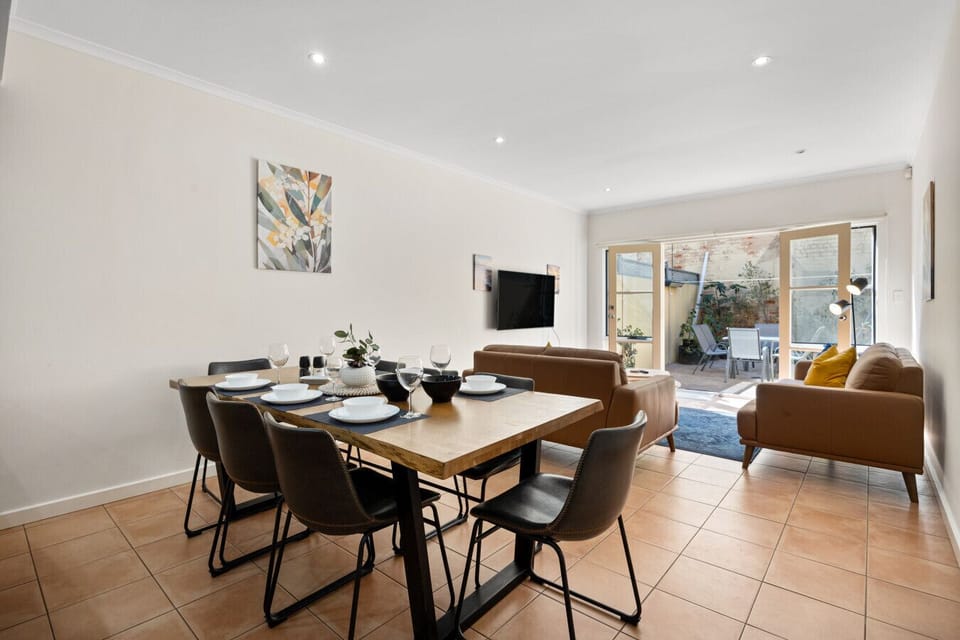Gather around the large dining table for memorable meals with family or friends, surrounded by chic furnishings and contemporary art.