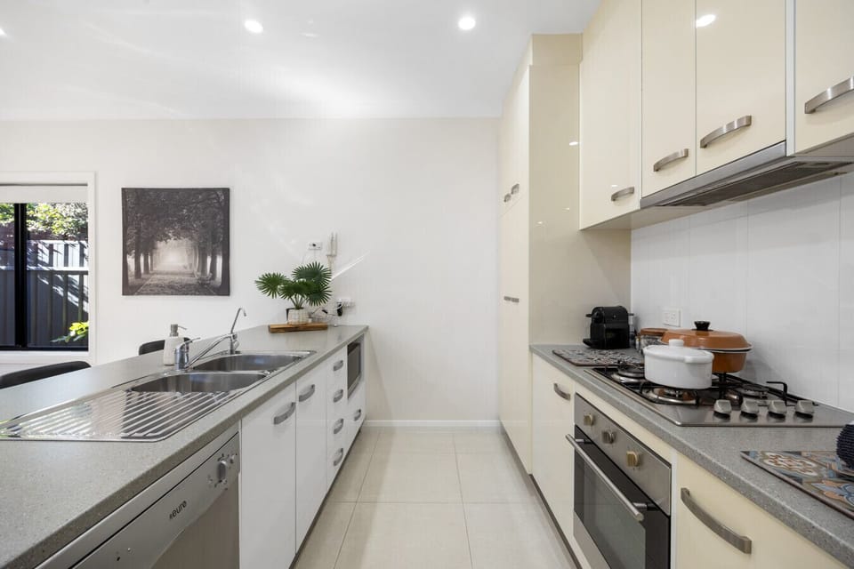 Everything at your fingertips – a streamlined kitchen equipped with modern appliances and loads of bench space.