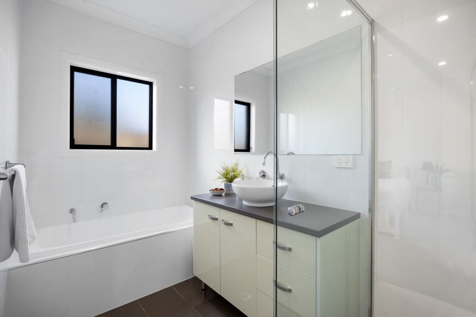 Unwind your way – enjoy a relaxing soak in the tub or get ready at the spacious mirrored vanity.