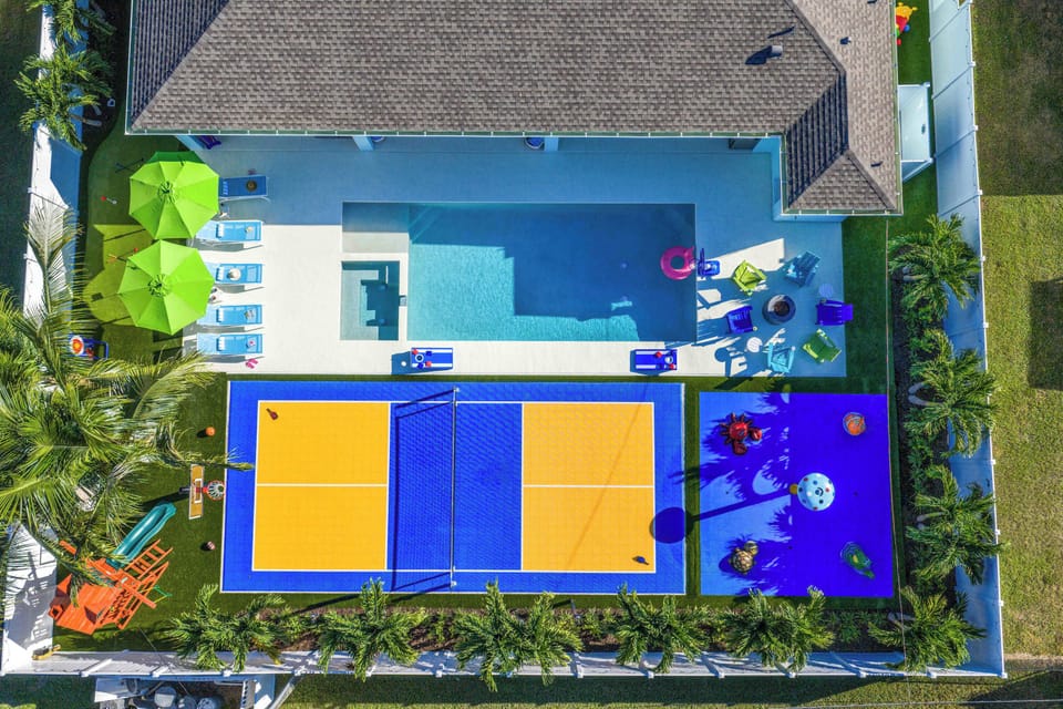 Backyard Oasis: Dive into fun with a sparkling pool, game courts, and vibrant lounging spots!