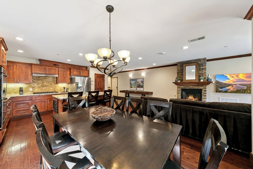 Gather your group around this spacious dining table while the chef prepares meals in the gourmet kitchen and warmth radiates from the stone fireplace.