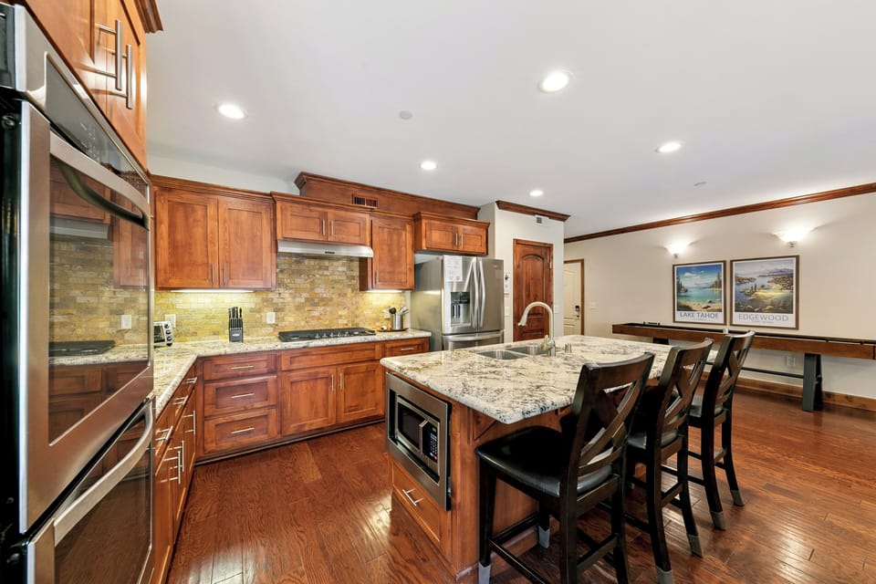 Cook memorable meals in this stunning kitchen featuring granite countertops, cherry cabinets, and a spacious island perfect for gathering.