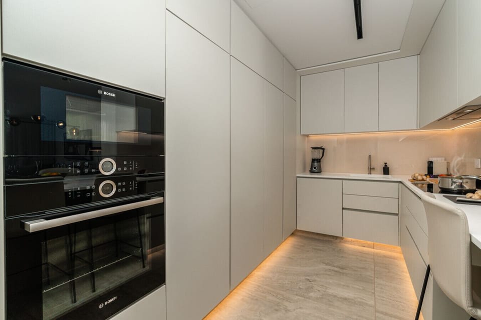 Modern kitchen with integrated Bosch appliances and sleek cabinetry.