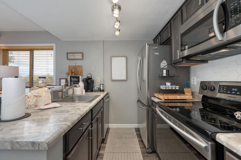 Your fully equipped kitchen awaits with modern appliances and marble countertops, perfect for creating memorable meals during your stay.