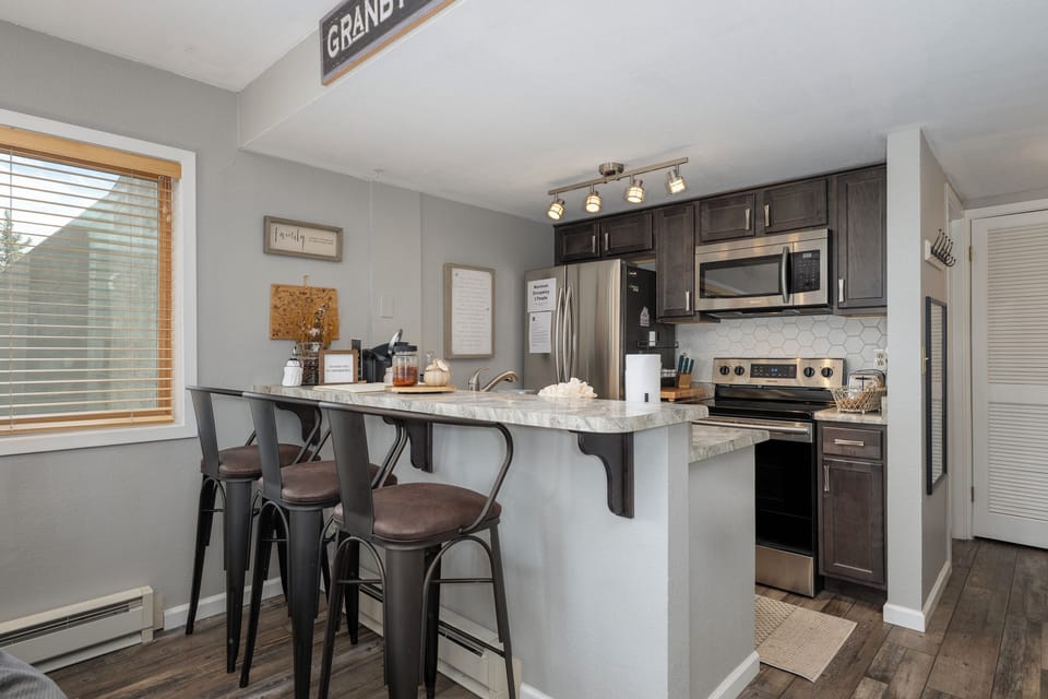 Your stylish kitchen features granite counters, stainless appliances, and a breakfast bar where you'll enjoy morning coffee with natural light streaming in.