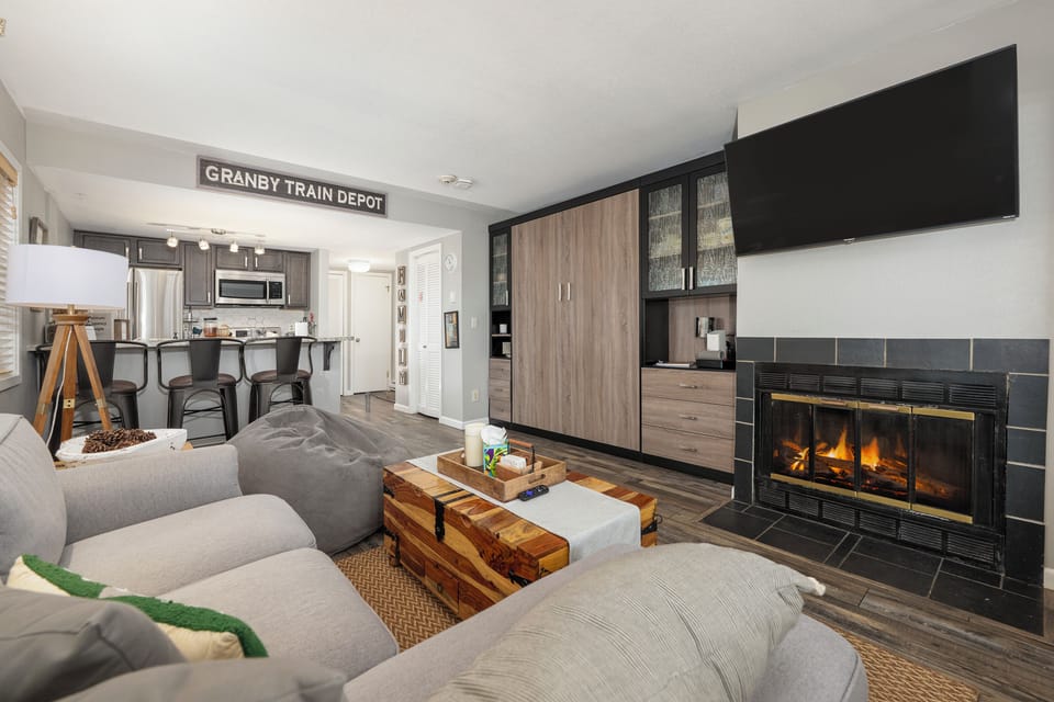 Sink into plush seating by your crackling fireplace while the open kitchen invites culinary adventures in this stylish retreat.