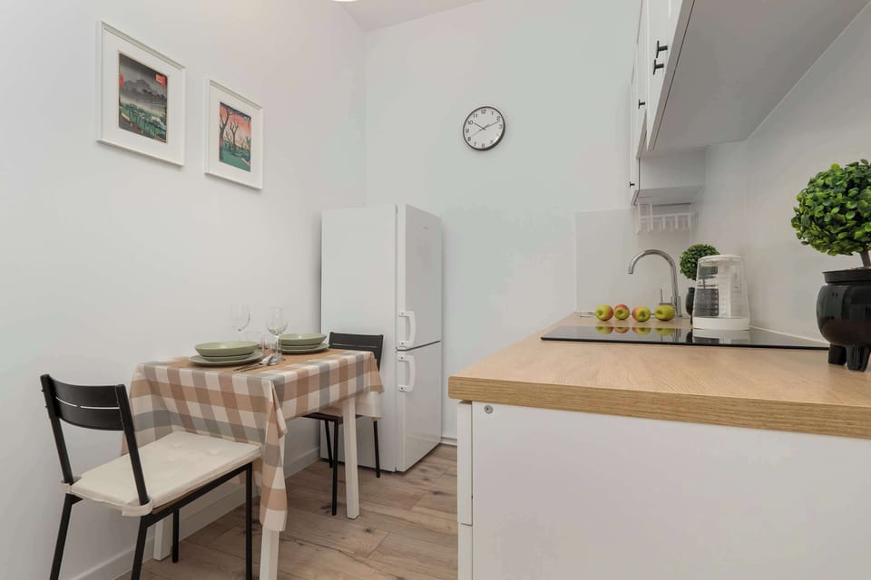 Another view of the kitchen sink, oven, and wooden countertop. The space looks practical and tidy.