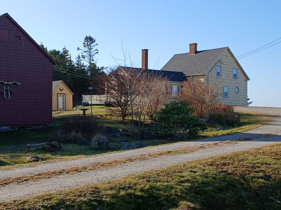 View of all buildings from the garden area - barn, garden shed and house