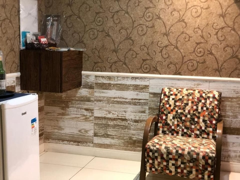 Luxury Suite, 1 Queen Bed | Living area | TV