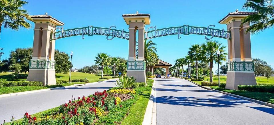 Enter the stunning entrance surrounded by colorful flower beds and palm trees, setting the perfect tone for your getaway. The beautiful architecture and inviting pathway promise a relaxing atmosphere that awaits you inside.