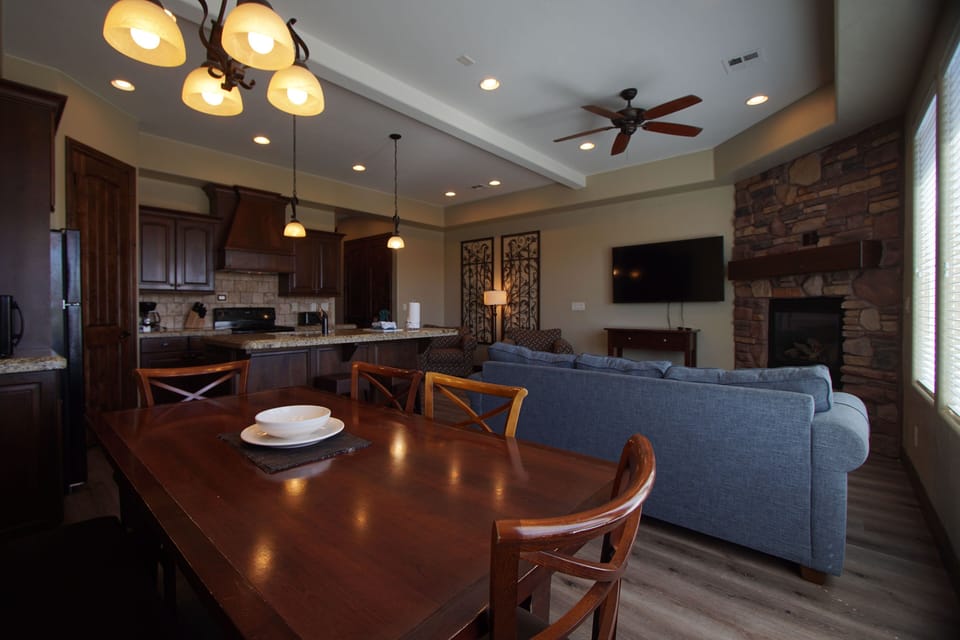 Open-concept living and dining area with fireplace and comfortable seating.