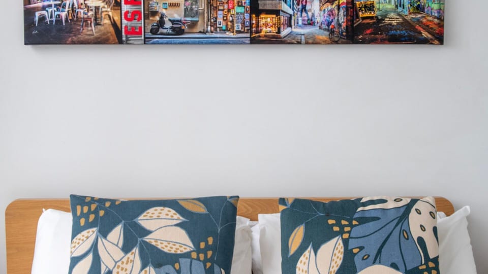 Retreat to a chic bedroom with fresh linens and vibrant décor.