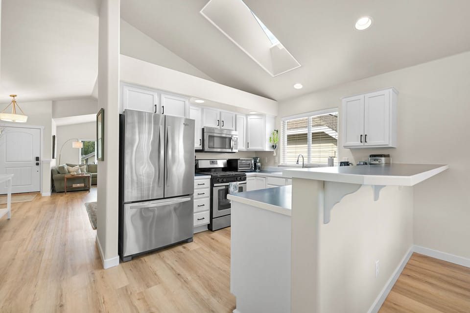 Kitchen with skylight and stainless steel appliances