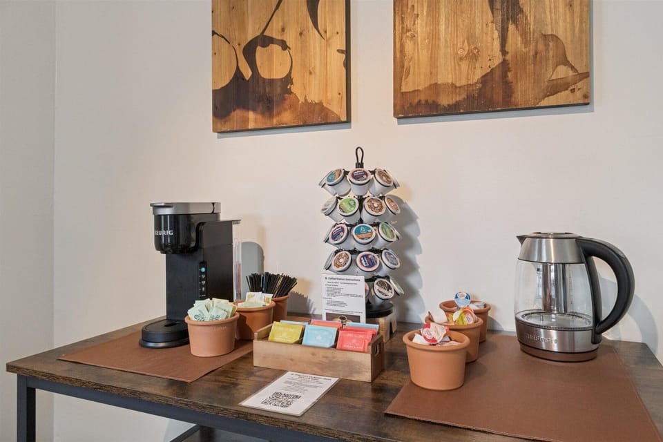 Morning moments at Varsity Alfresco—our industrial-chic nook features a high-top table, bike-pedal stools, and a stocked coffee station. Comfort and connection near Notre Dame.