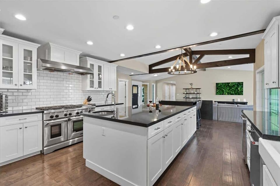 Fully equipped kitchen with stainless steal appliances and an informal dining area with seating for 4 guests.