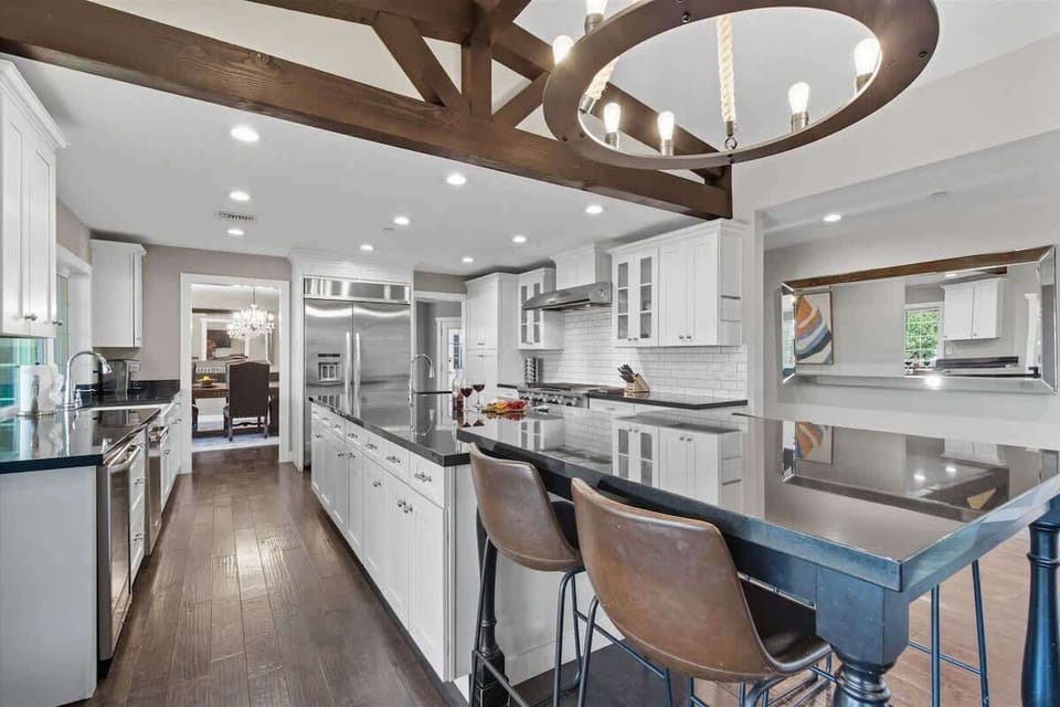 Fully equipped kitchen with stainless steal appliances and an informal dining area with seating for 4 guests.